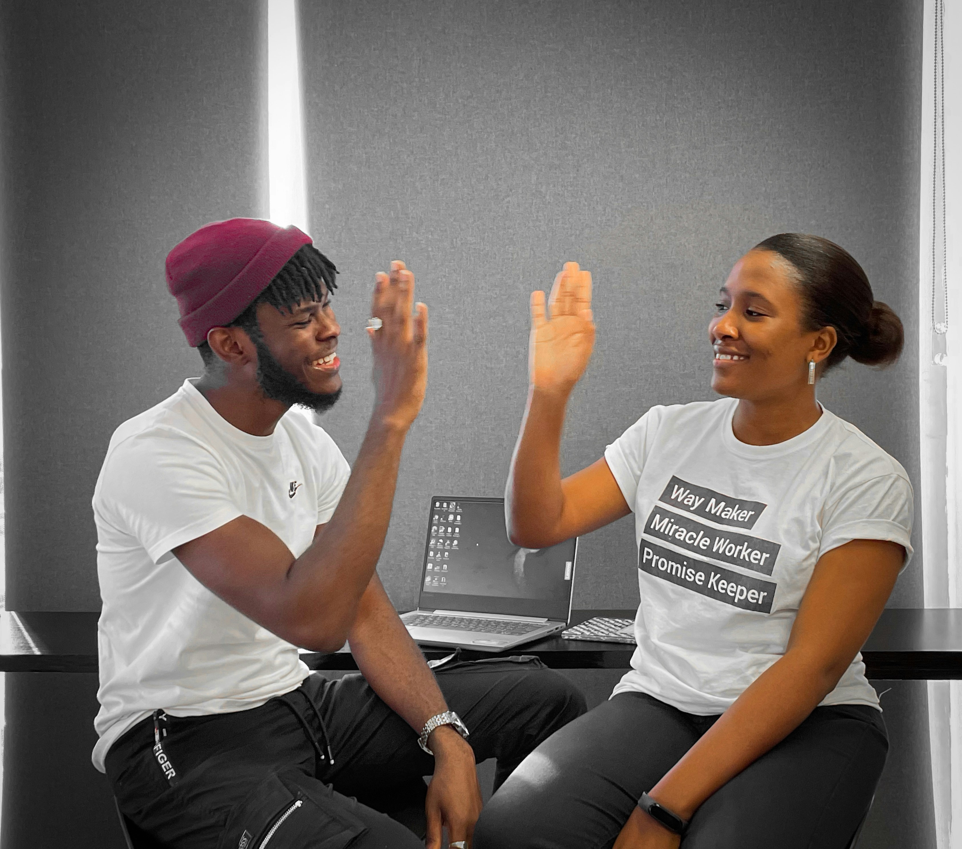 Young adult and coach celebrating progress with a high five